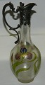 Art nouveau decanter in glass with silver plate top.