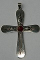 Cross in silver with red stone