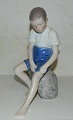 B&G figur i porcelæn af dreng på sten.